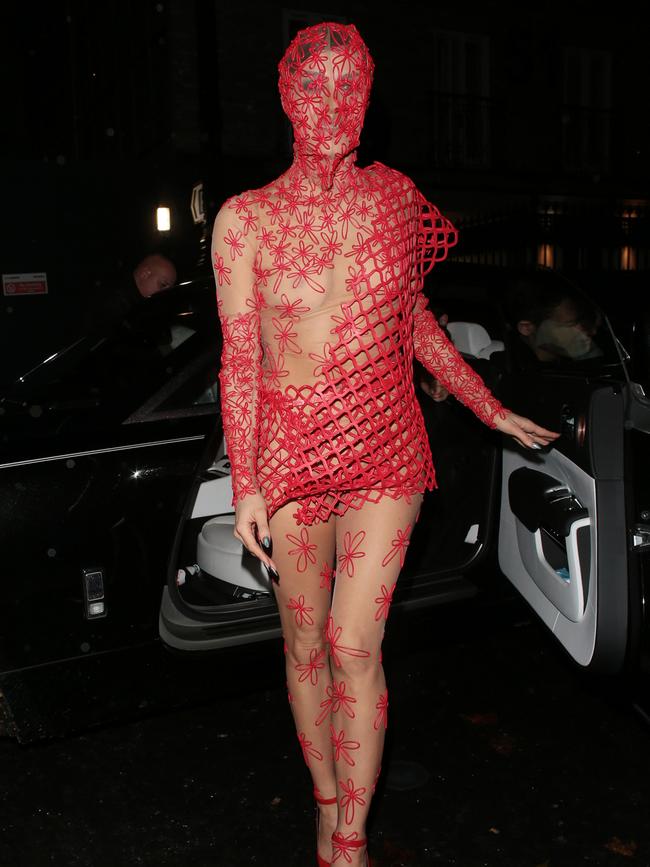 The outfit was comprised of a sheer, flesh coloured body shirt adorned with red flowers and strategically placed netting. Picture: Splash News/Media Mode