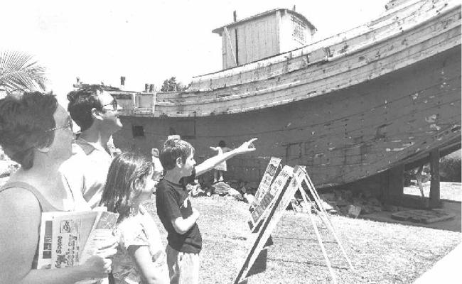 Middlemount family, Suzanne and Bill Ward, with children Melissa, 10, and Scott, 12, take a look at the old junk, which sat at the City Gates for many years. The family was enjoying a school holiday visit to Mackay in 1989. Picture: Daily Mercury Archives