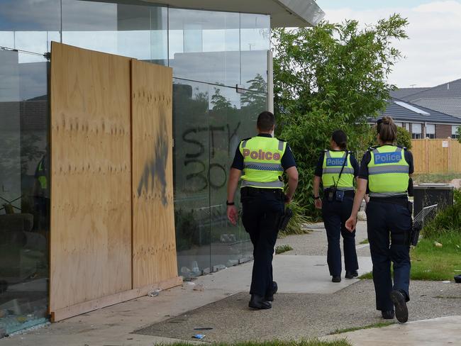 Police patrol the trashed Ecoville Community Centre. Picture: Nicole Garmston