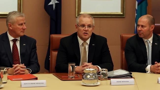 Following the swearing in ceremony, Prime Minister Scott Morrison (centre) got down to business with his Deputy PM Michael McCormack (left), and Treasurer Josh Frydenberg (right). Picture: Kym Smith