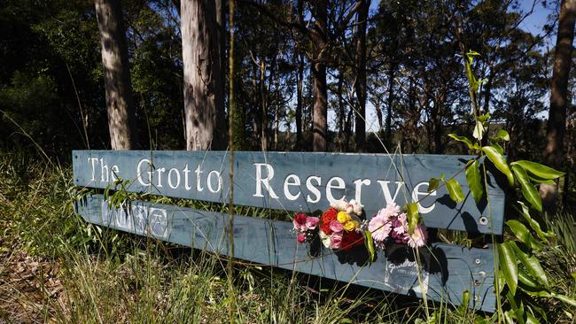 Community members have laid flowers at the entrance of the The Grotto Reserve bushwalking area in North Nowra where police believe they discovered the body of six-year-old Airlie Montgomery who went missing on Sunday afternoon. Picture: Richard Dobson