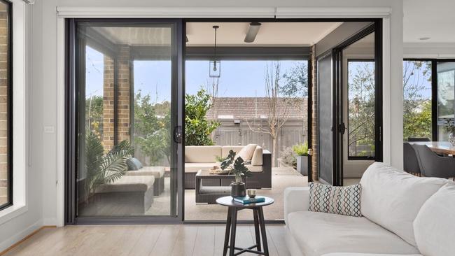 The open-plan kitchen, living and dining area opens out to a covered outdoor entertaining space.