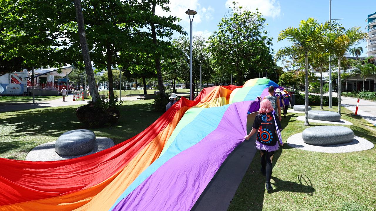 A small group of LGBTIQ people and supporters paraded along the Cairns Esplanade with a huge rainbow flag for the Pride Stride, part of the Cairns Pride Festival. Picture: Brendan Radke