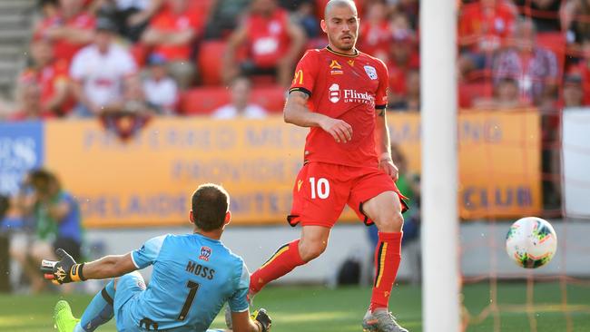 Adelaide’s James Troisi slides the ball past Jets goalkeeper Glen Moss to seal a 2-1 win for the Reds at Coopers Stadium. Picture: Getty Images