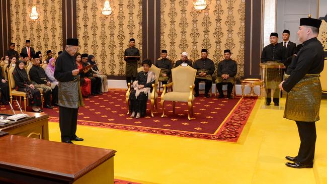 Mahathir Mohamad, left,  taking an oath as he is sworn in as Malaysia's new prime minister at the National Palace in Kuala Lumpur.