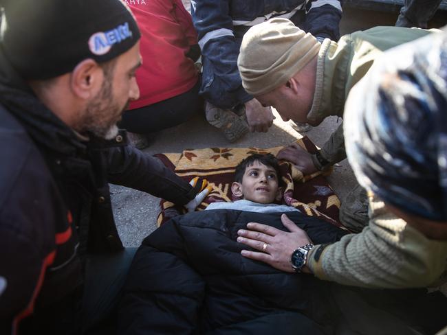 Rescue workers tend to Ahmet Findik, 11, at the site of a collapsed building 60 hours on from the earthquake in Hatay, Turkey. Picture: Getty Images