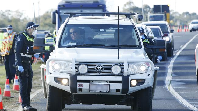 Cars queued up at a coronavirus border checkpoint in Victoria. Picture: Alan Barber