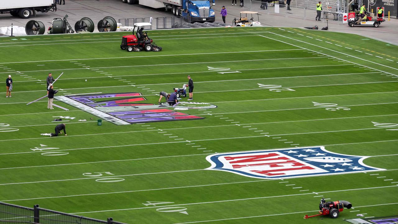 Workers paint a Super Bowl LVIII logo on the field outside of Allegiant Stadiu. Picture: AFP