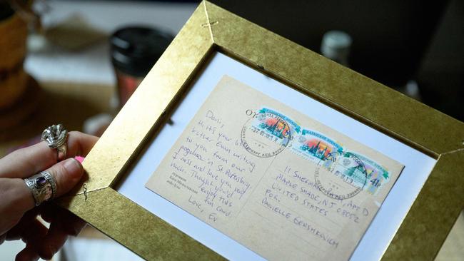 Danielle Gershkovich, sister of detained journalist Evan Gershkovich, shows the back of a framed postcard sent by her brother. Picture: AFP