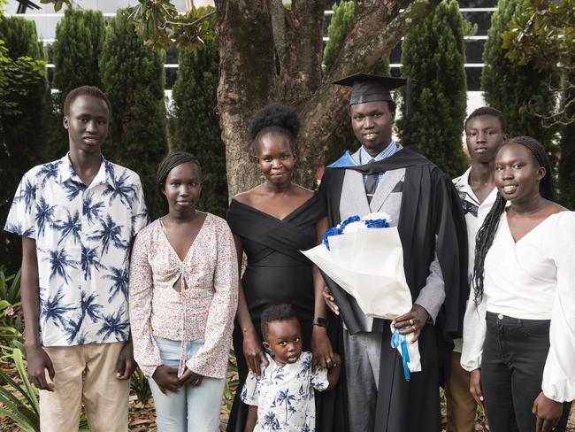 Bachelor of Human Services graduate Ezekiel Aleer with (from left) Aleer Malual, Regina Aleer, Saeed Aleer (front), Mary Saeed, David Aleer and Grace Aleer at a UniSQ graduation ceremony at Empire Theatres, Tuesday, February 13, 2024. Picture: Kevin Farmer