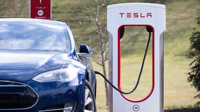 A Tesla Model S sedan is plugged into a Tesla Supercharger electrical vehicle charging station. Picture: Saul Loeb/AFP