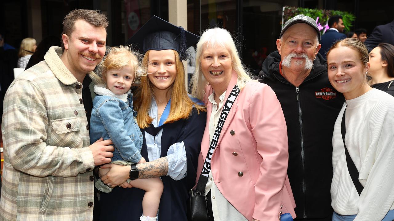 Deakin University graduate Georgia Haynes with partner Brandan Young, daughter Billie,2, parents Kerri and Steven and twin Marissa McCrimmon. Picture: Alison Wynd