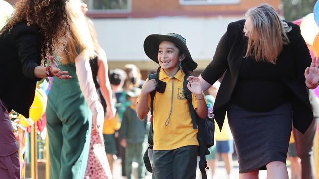 Pictured with her teacher Jenna Arzapitian for her first day back at Homebush West Public School is Dakshanya Yakakumar. Picture: Richard Dobson