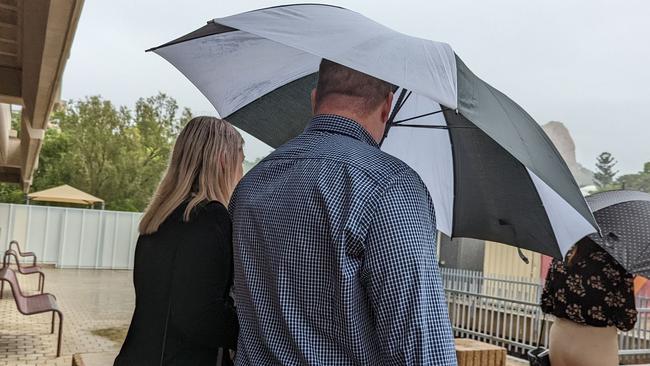 Ashley Rogers used an umbrella to hide his face from the camera outside Townsville court precinct after his sentencing.