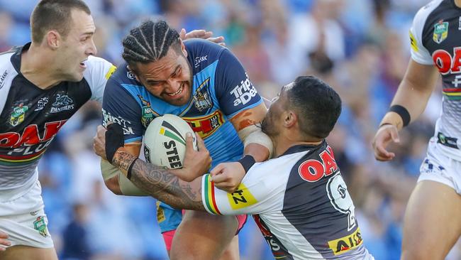 Konrad Hurrell of the Titans (centre) is tackled during the Round 22 NRL match between the Gold Coast Titans and the Penrith Panthers at Cbus Super Stadium on the Gold Coast, Saturday, August 11, 2018. (AAP Image/Glenn Hunt) NO ARCHIVING, EDITORIAL USE ONLY