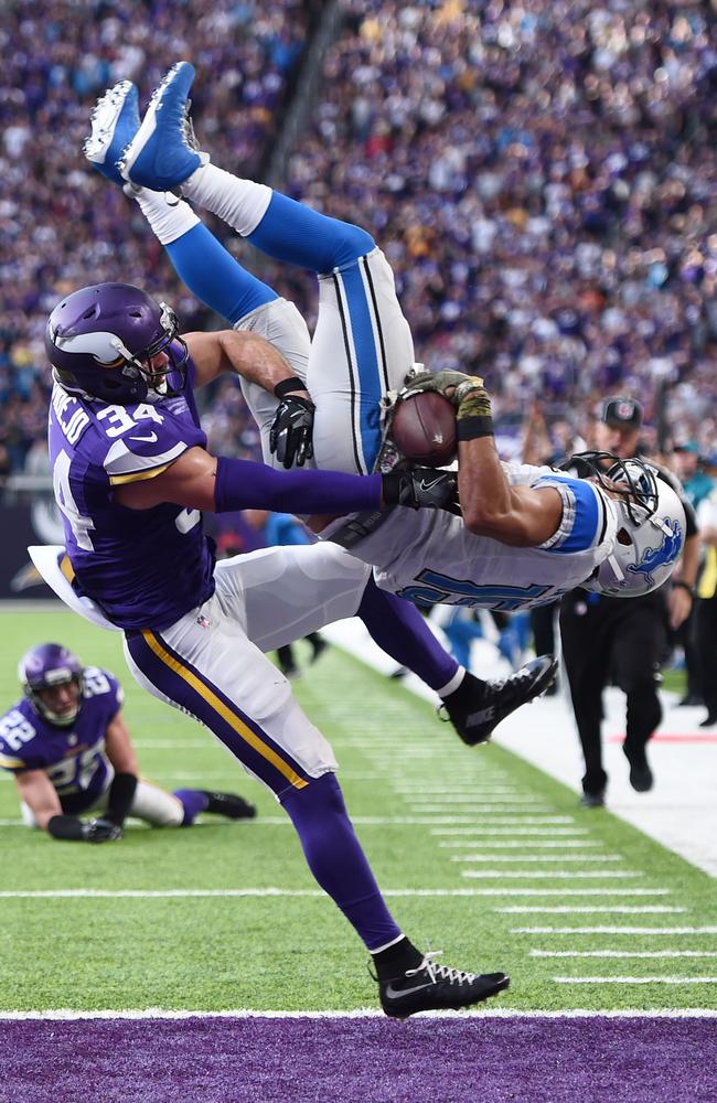 Golden Tate #15 of the Detroit Lions leaps into the end zone for the go ahead touchdown.