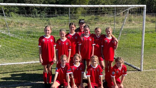 Celebrating their team of the week win are Nambour Yandina players (back from left) Aylah Gilbertson, Elise Lamperd, Sienna Swan, Isabella Lovekin, Savannah Ginn, Lily Winslade, Emily Walkerden-Ridge (coach), Emily Coster, Lucy Kerr, Meila Ginn, Lyla Phillips