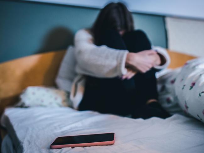 pedophile generic Sad teen with a phone in her bedroom