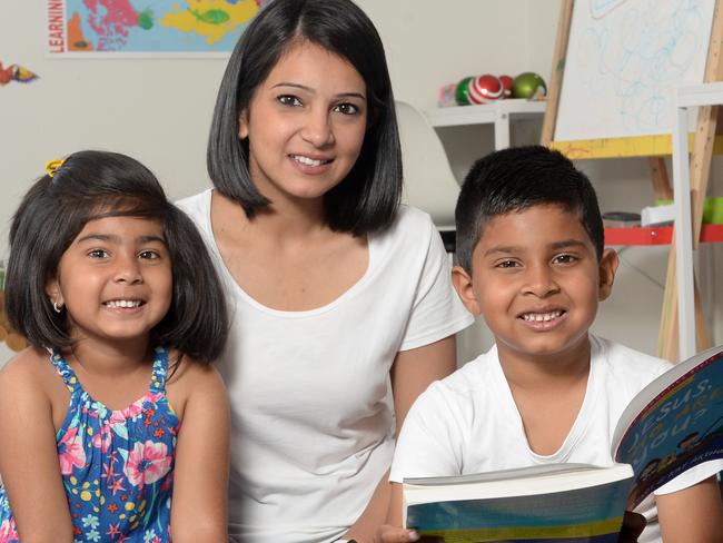 Jeshlyn Ranasinghe helps her kids Jiya, 4, and Aiden, 6, prepare for the new school year at their house at Clyde North. Picture: Andrew Henshaw