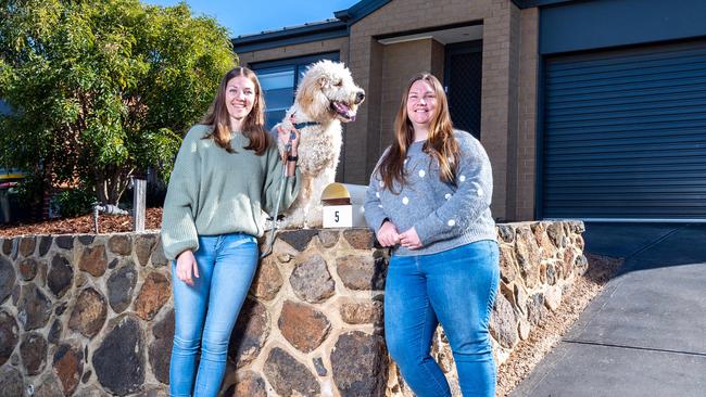 Arianna Merewether with her wife Annette Merewether and dog Henry. The couple recently purchased their first home using the Federal Government's First Home Loan Deposit Scheme. Picture: Jake Nowakowski.