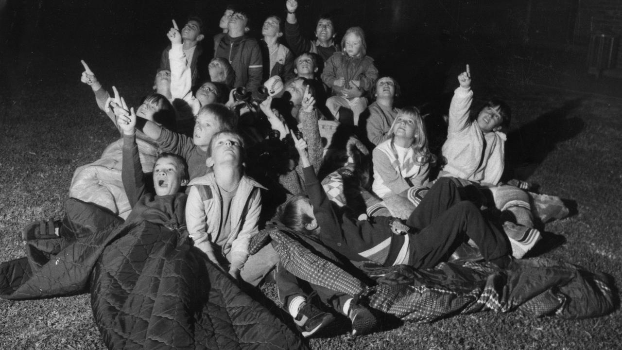 Pupils from Plympton Primary School in South Australia pointing at the sky as they camp out overnight to see Halley's Comet passing by in April 1986.