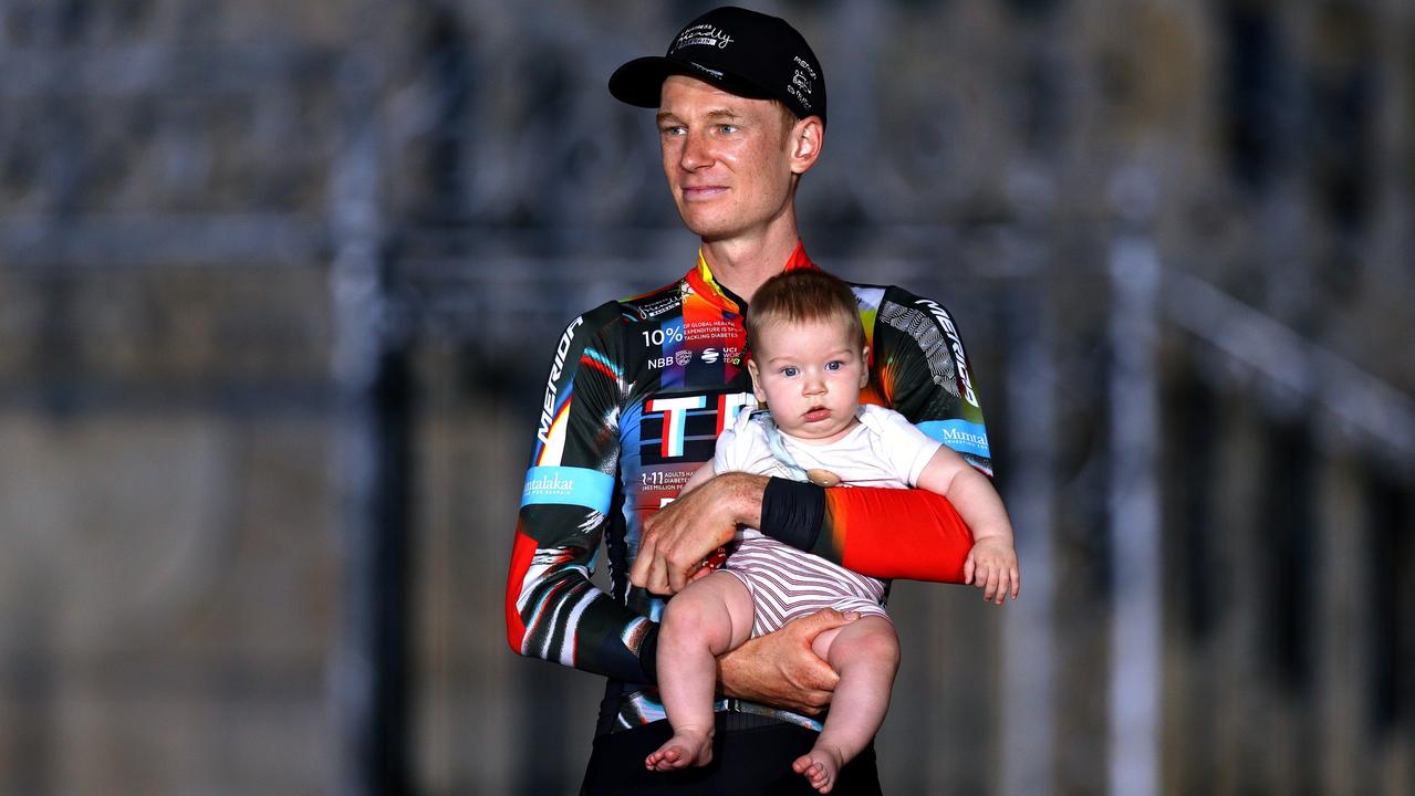 Jack Haig and his baby celebrate finishing third in the Tour of Spain 2021. Picture: Gonzalo Arroyo Moreno/Getty Images