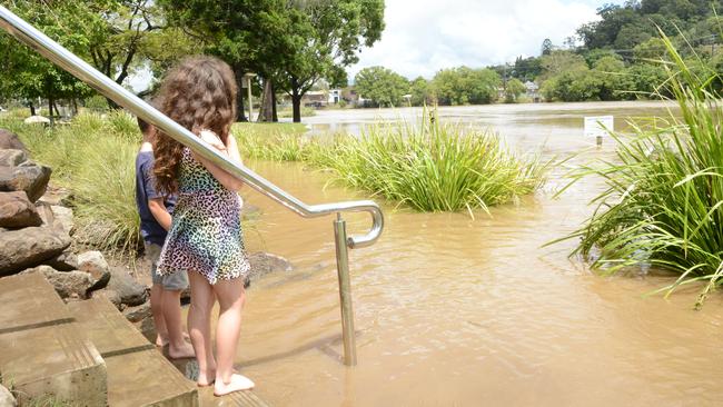 Emily and Mason Randles assess the flooding at Budd Park on the Tweed Rivers in Murwillumbah on Tuesday, December 15, 2020. Picture: Liana Boss