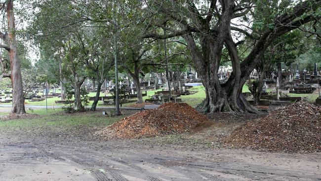 Garden mulch is stored on top of unmarked pauper’s graves at Toowong Cemetery. Picture: Steve Pohlner