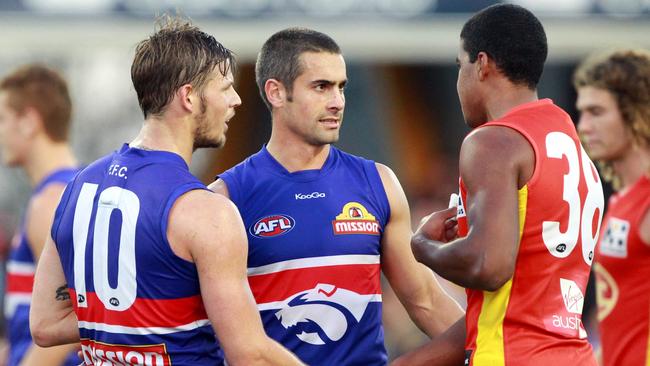 Justin Sherman and Daniel Giansiracusa talk with Wilkinson after his debut game, in 2011. Picture: Darren England