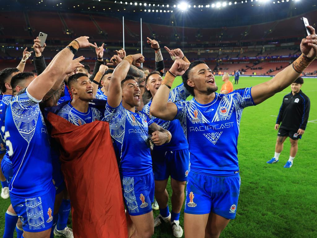 Stephen Crichton of Samoa takes a selfie with teammates following their team's victory. Picture: Matthew Lewis/Getty Images for RLWC