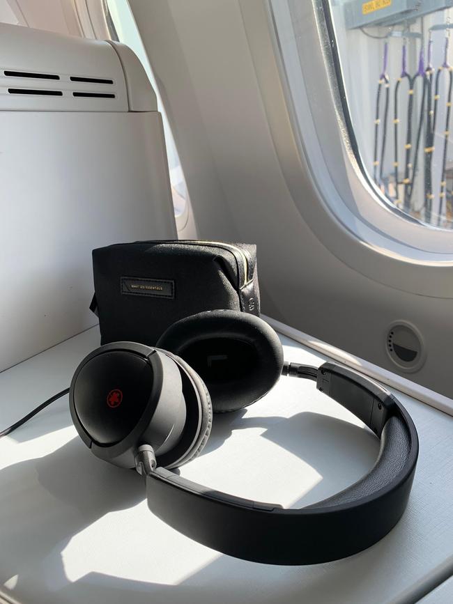 Passengers receive a Want Les Essentiels toiletry kit and headphones.