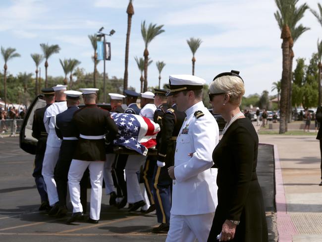 Military pallbearers escort the casket of John McCain to a hearse as wife Cindy McCain and son Jack McCain follow. Picture: Getty Images/AFP