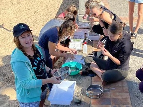 Volunteers sifting sand in the search for microplastics collected from the beach along West Esplanade in Manly Cove. Picture: AUSMAP