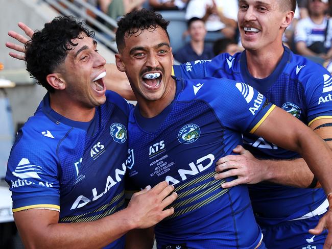 SYDNEY, AUSTRALIA - MARCH 09: Bailey Simonsson (l) and Shaun Lane of the Eels celebrate with Morgan Harper (c) of the Eels after he scored a try during the round one NRL match between Parramatta Eels and Canterbury Bulldogs at CommBank Stadium, on March 09, 2024, in Sydney, Australia. (Photo by Brendon Thorne/Getty Images)