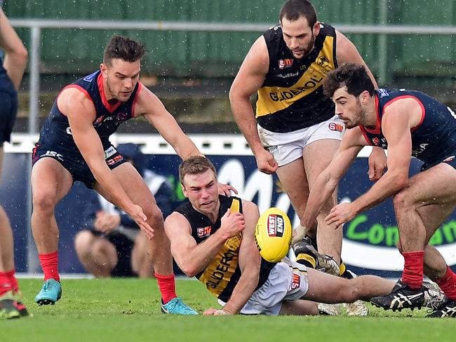 16/06/18 - SANFL: Norwood v Glenelg at Norwood Oval.  Glenelg's Andrew Bradley fires out a handpass.Picture: Tom Huntley