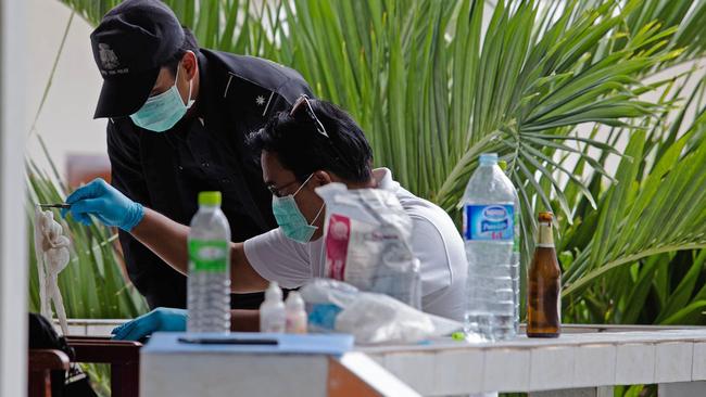 Thai forensic investigators inspect a hotel room where the two were staying. AFP PHOTO