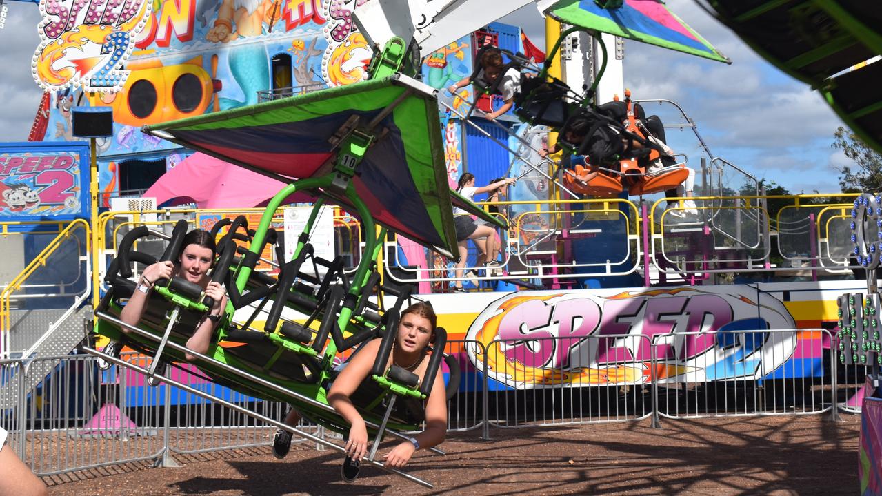 (L) Tayissa Richters and Rosie White fly through the air on the Cliff Hanger ride at the Fraser Coast Ag Show.