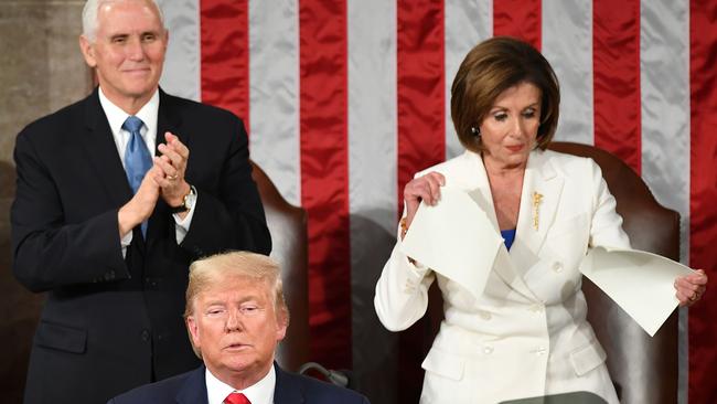 Mike Pence claps as Democrat House Speaker Nancy Pelosi rips a copy of Donald Trump’s speech after he delivers the State of the Union in Washington. Picture: AFP