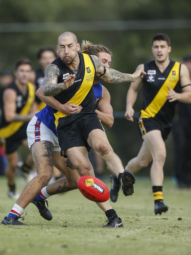 Seaford’s Dean Wiliamson kicks under pressure.