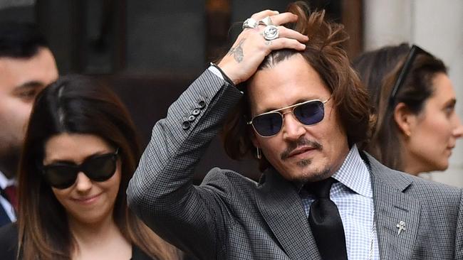 Johnny Depp gestures as he leaves after attending a hearing of his libel trial against News Group Newspapers on Thursday. Picture: Justin Tallis/AFP