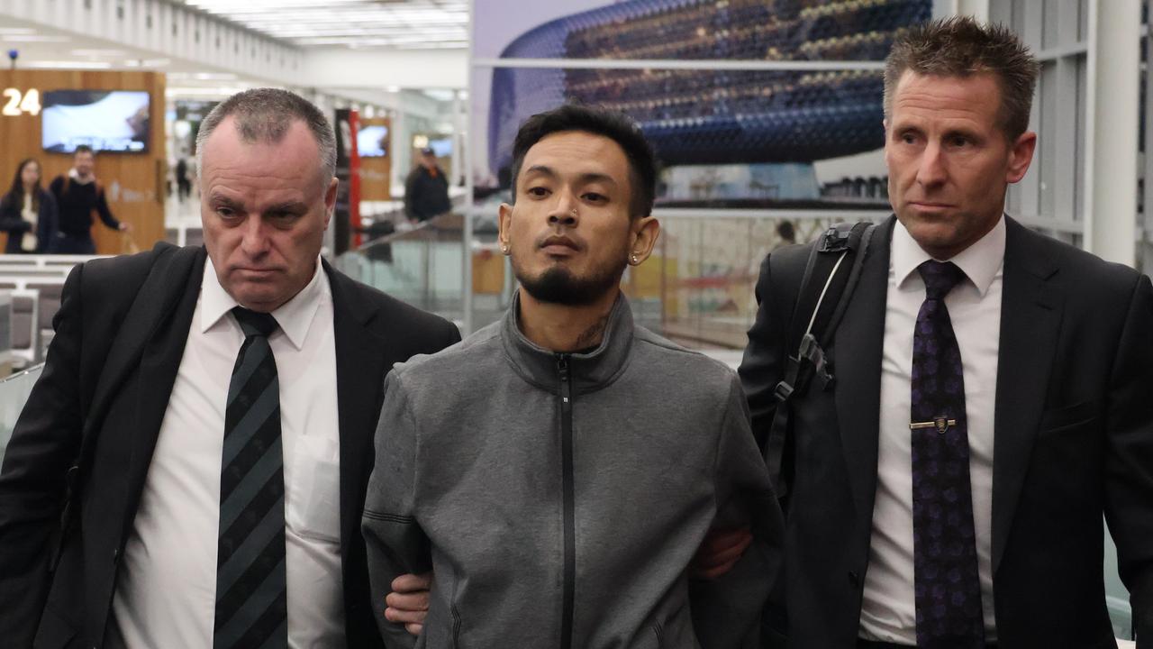 Detectives led Mr Rim through Adelaide Airport at about 8.15pm Saturday after his extradition from Melbourne. Picture: Riley Walter