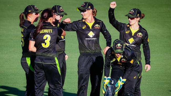 Australian players celebrate their victory in the first T20 against New Zealand.