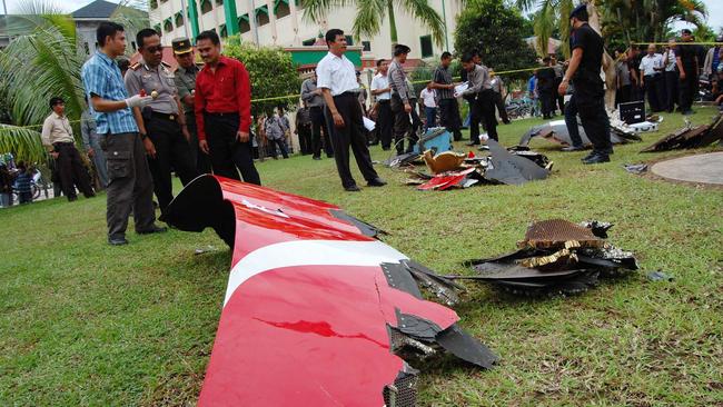 Investigators examine debris from a Qantas jet that suffered engine failure over the Indonesian island of Batam.