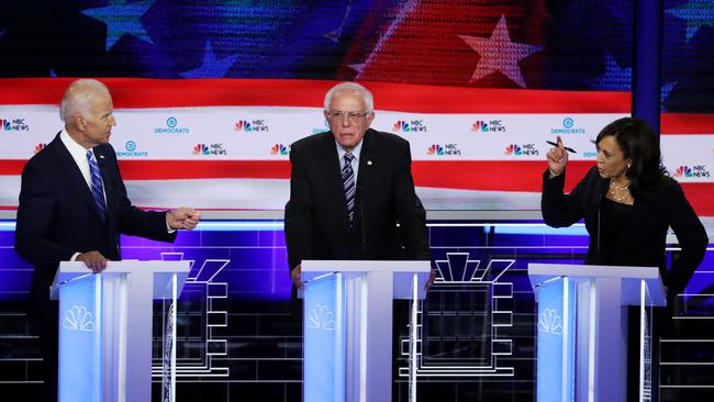 Senator Kamala Harris, right, and former Vice President Joe Biden, left. exchange words as Senator Bernie Sanders, centre, looks on during the second night of the first Democratic presidential debates. Picture: Drew Angerer/Getty/AFP