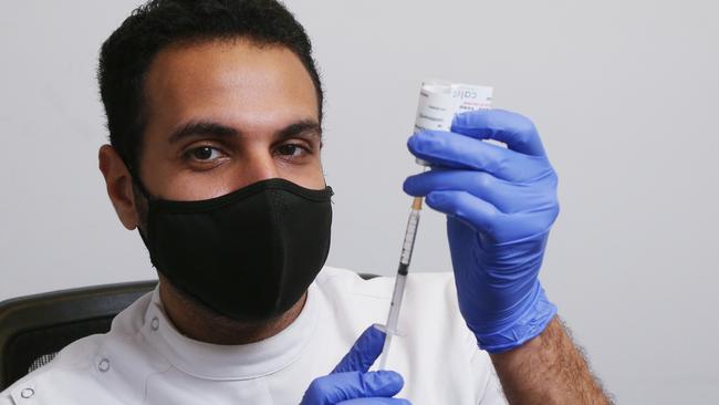 Calanna Pharmacy Woree manager Mo Elliessy prepares a syringe with a vial of the AstraZeneca Covid-19 vaccine. Picture: Brendan Radke