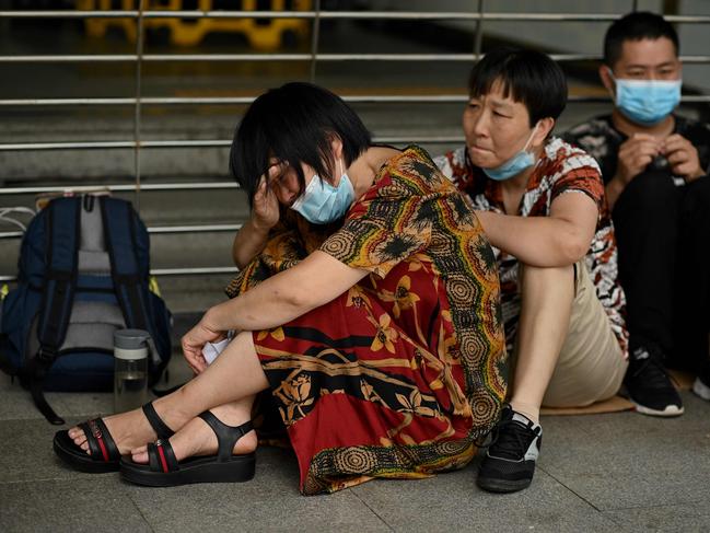 People gather Evergrande’s headquarters in Shenzhen. Picture: Noel Celis/AFP