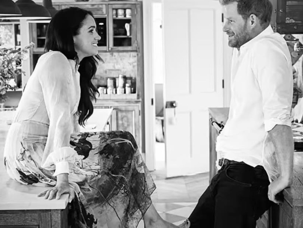 In a previously unseen image, Meghan Markle, wearing Oscar de la Renta, chats to Prince Harry at Frogmore Cottage. Picture: Netflix