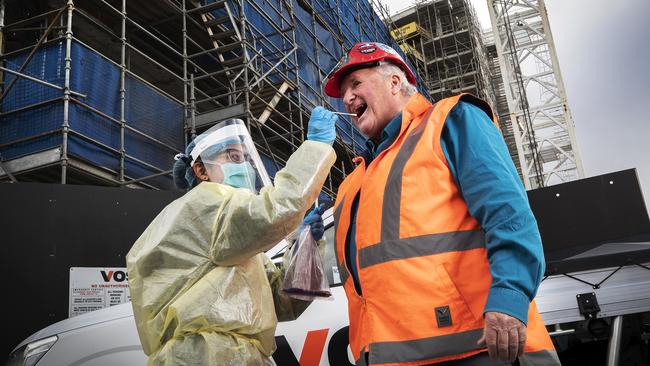 Nurse Vicky Liu tests CFMEU State Organiser Kevin Harkins at a construction site at Hobart. Picture: Chris Kidd