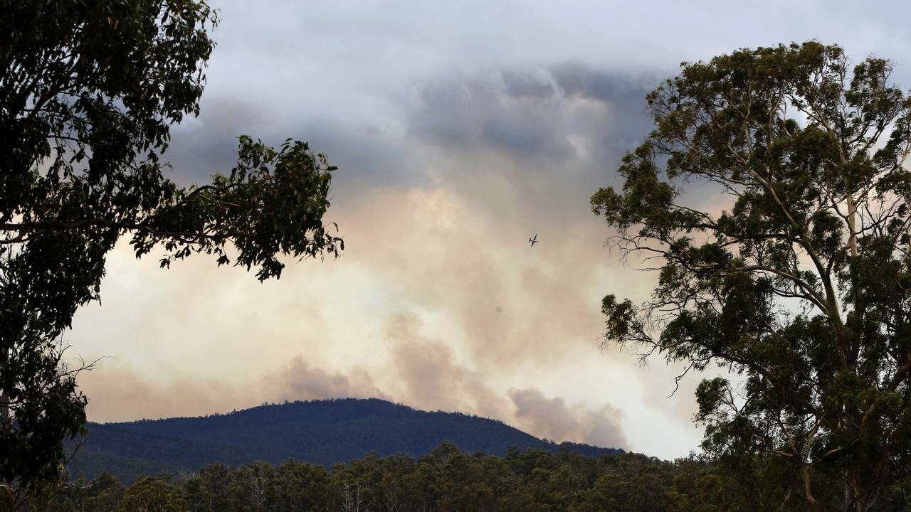 A military Hercules aircraft dropped thousands of litres of water on the fire line as it encroached on the Judbury area in the Huon Valley yesterday. Picture: PATRICK GEE
