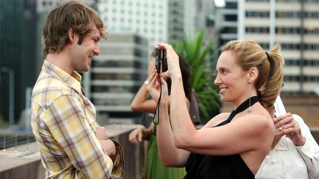 Actor Toni Collette takes a picture of her husband Dave Galafassi on the roof of the Museum of Contemporay Arts at the Rocks in Sydney.